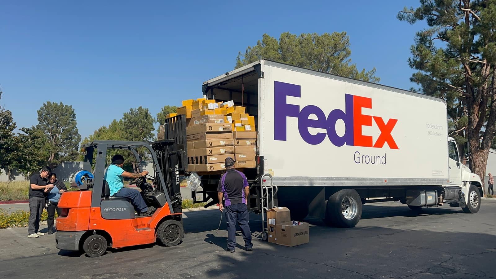 ShipHub (PAX Trading Inc) fulfillment team loading palletized customer orders into a FedEx Ground truck for shipping
